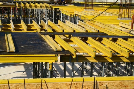 View at yellow constructions which are used to build flat board for a new level