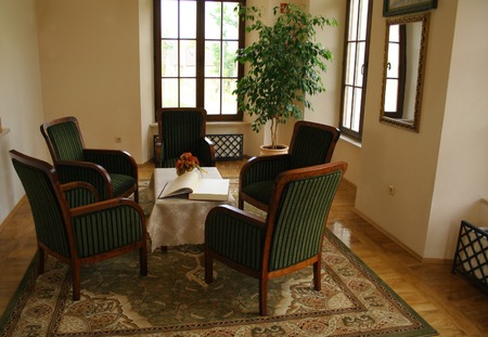 view at room with five chairs and table with a bookの写真素材