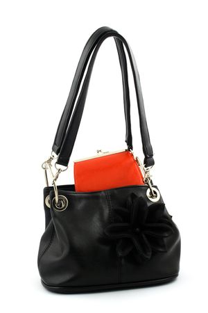 Black handbag with handles up and red wallet on a white backgroundの写真素材