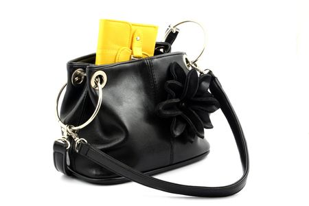 View at yellow wallet put in a black handbag on a white backgroundの写真素材