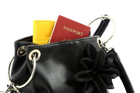 close up at black handbag with yellow wallet and passport put inside on a white backgroundの写真素材