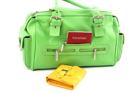 View at green handbag with passport in a pocket and yellow walletの写真素材