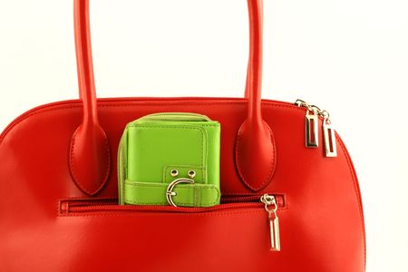 Close up at nice red handbag with green wallet in side pocketの写真素材