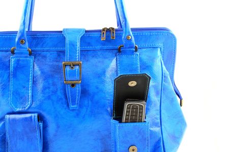 Close up at blue handbag with a cellphone in a pocketの写真素材