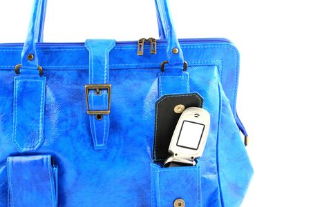 Cellphone with blank screen in a pocket of blue handbagの写真素材