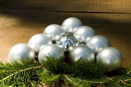 A triangle made of matt and one silver christmas ballsの写真素材