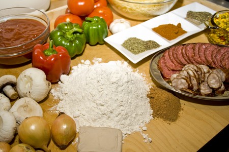 Colourful table of fresh ingredients ready to make pizzaの写真素材