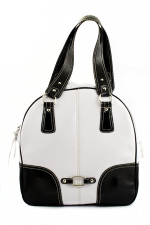 Front view at woman's nice black and white handbag on a white backgroundの写真素材