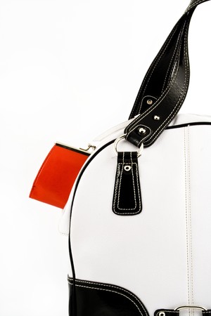 Red wallet put into black and white handbag on a white backgroundの写真素材