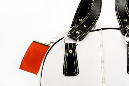 Close up at red wallet in white leather handbag on a white backgroundの写真素材