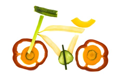 Nice colourful bike made from vegetables and fruits isolated on whiteの写真素材