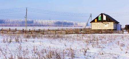 House under construction on the edge of the village.Winter landscape.の写真素材