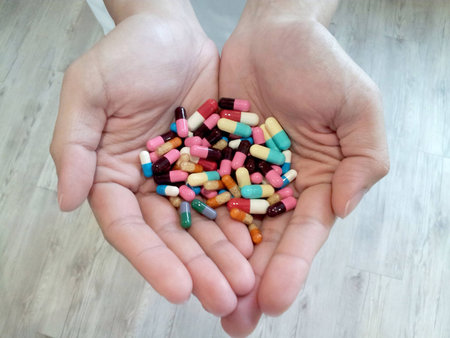 Hands with a variety of pills.の素材