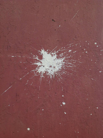 White paint spatter on red wall