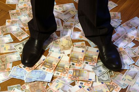 A man is standing on the cash moneyの写真素材