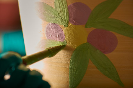 Craftsman painting a flower in a potの写真素材