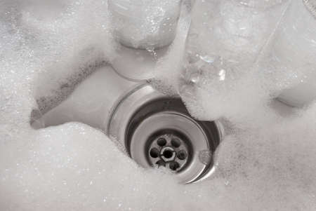 Sink and drain with foamの写真素材