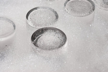 several soap covered glasses in a sinkの写真素材