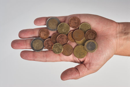 Hand with different euro coins