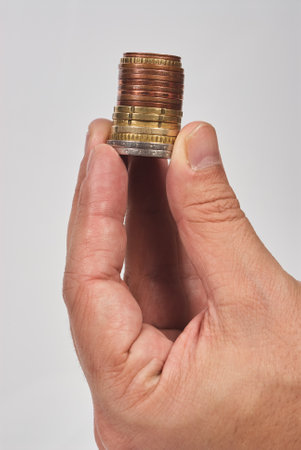 Hand picking up different euro coinsの写真素材