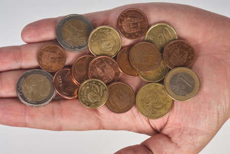 Hand with different euro coinsの写真素材