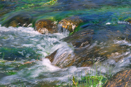 Movement of river water over rocksの写真素材