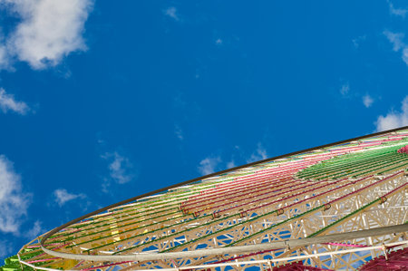 Detail of a ferris wheel in an amusement park with the sky in the backgroundの写真素材