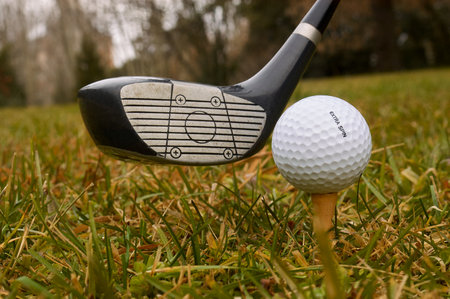Detail of golf club hitting a ballの写真素材