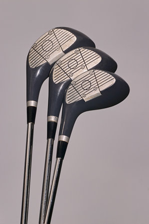 Detail of three golf clubs with a neutral backgroundの写真素材