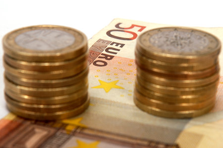 Pile of euro coins on a billの写真素材