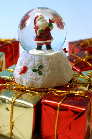 Santa Claus inside a crystal ball, surrounded by giftsの写真素材