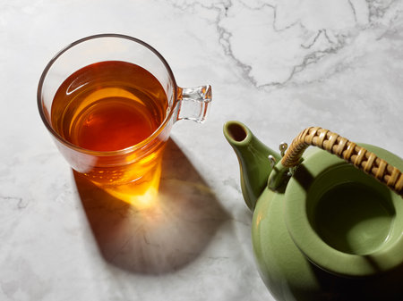 Set of porcelain teapot and glass cup with teaの写真素材