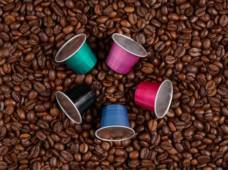 Five coffee capsules on a heap of coffee beansの写真素材