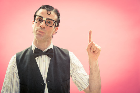 Nerd man on pink point to ideaの写真素材