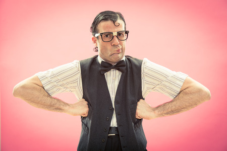 Nerd man with glasses portrait on pinkの写真素材