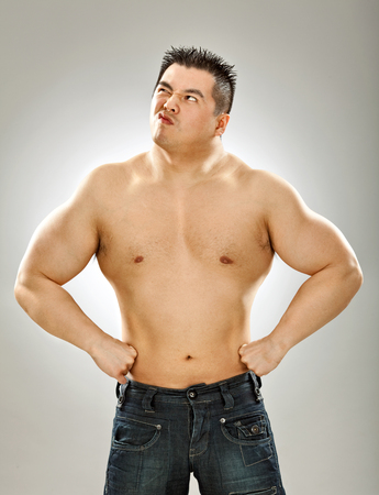 asian body builder naked show muscle on grey backgroundの写真素材