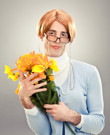 ugly woman with glasses hold flowers on grey backgroundの写真素材