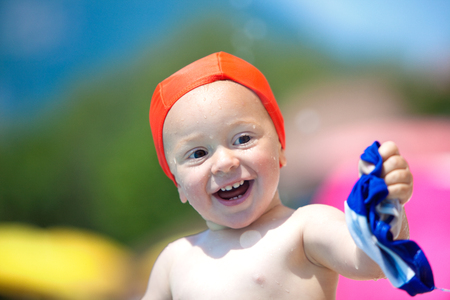 happy child with swimming pool cap have fun in a poolの写真素材