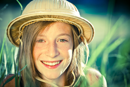 beautiful young explorer girl with hat at parkの写真素材