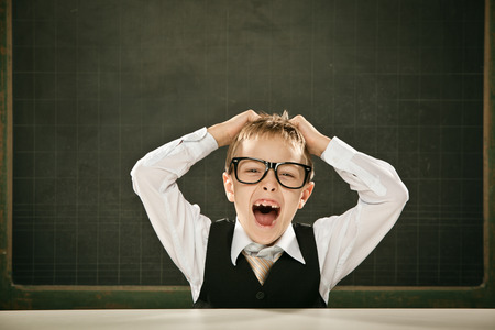 young nerd student with glasses and blackboardの写真素材