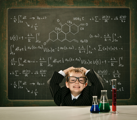 young elegant clever chemistry student or scientist serious pose with blackboard