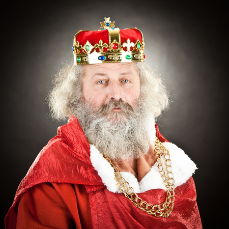 old king with crown and jewels isolated on black
