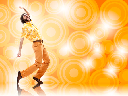 1970s vintage man dance with orange backgroundの写真素材