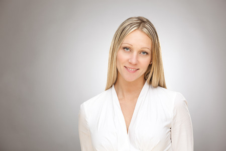 european caucasian blonde happy business woman studio portraitの写真素材