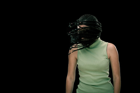 Beautiful dread young woman dance isolated on black
