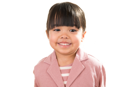 Asian smiling little girl portrait isolated on whiteの写真素材