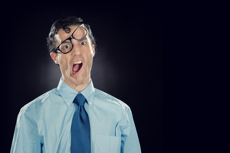 nerd businessman with glasses make funny face isolated on black