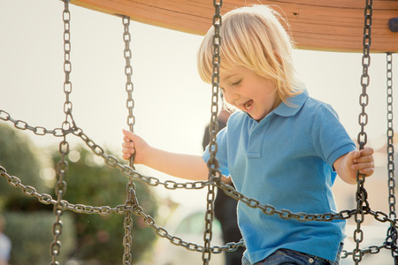 happy smiling blond child play in the parkの写真素材