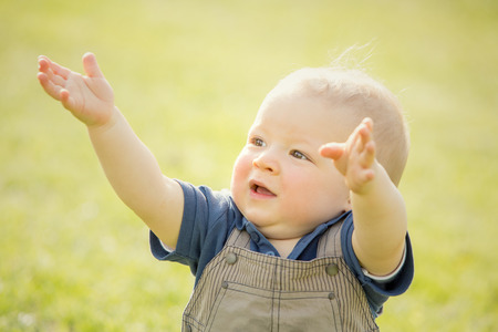 happy smiling blond child play in the parkの写真素材