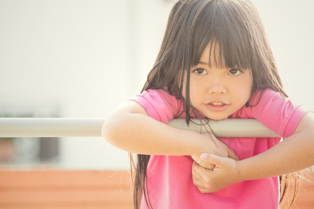 happy asian smiling child play in a gardenの写真素材